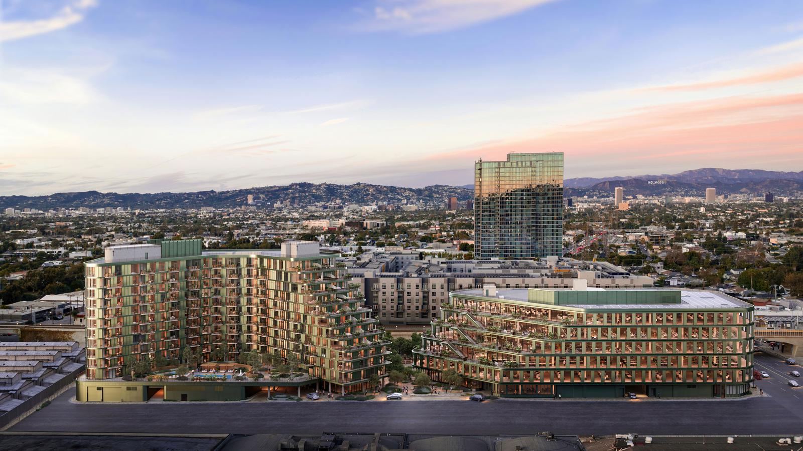 Habitat Los Angeles at dusk — aerial view of the 12-story residential building and the curved 6-story commercial building on the La Cienega corridor